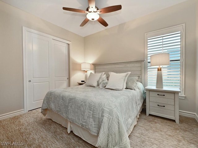 carpeted bedroom with a closet and ceiling fan