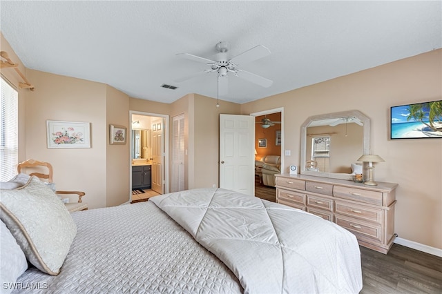 bedroom featuring baseboards, visible vents, connected bathroom, ceiling fan, and wood finished floors