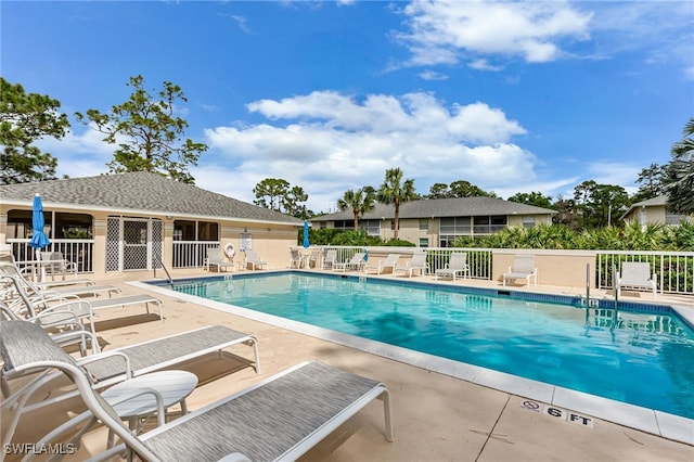 pool featuring a patio and fence