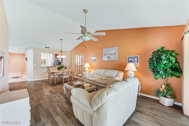 living area featuring lofted ceiling, visible vents, ceiling fan, wood finished floors, and baseboards