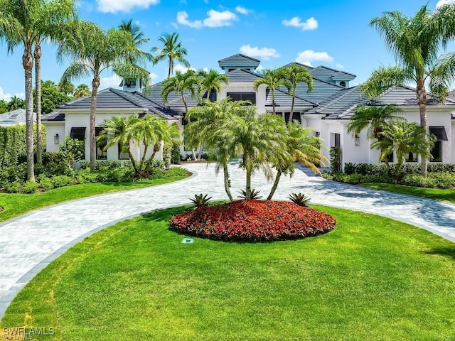 mediterranean / spanish-style home with a front lawn