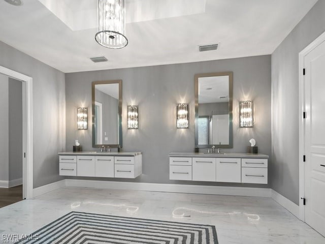 bathroom featuring vanity and a chandelier