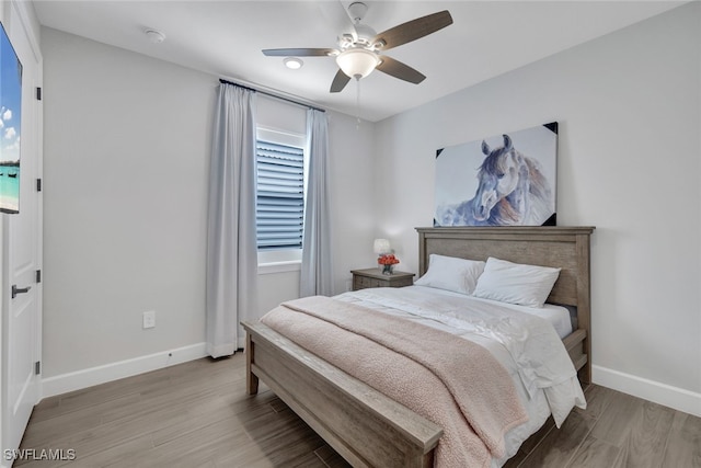 bedroom with ceiling fan and light hardwood / wood-style flooring