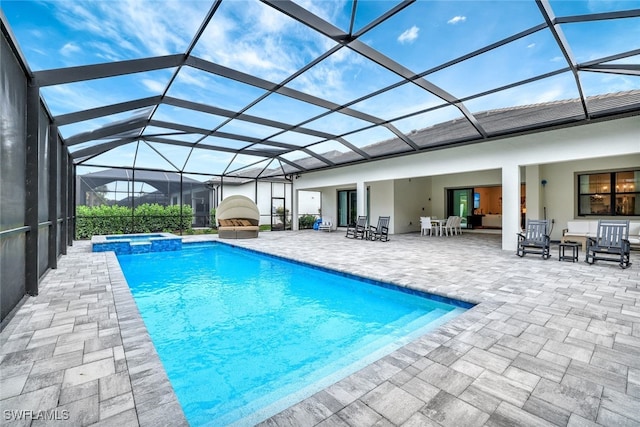 view of pool with an in ground hot tub, an outdoor hangout area, a patio area, and glass enclosure