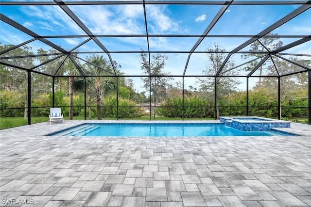 view of swimming pool with a lanai, a patio, and an in ground hot tub