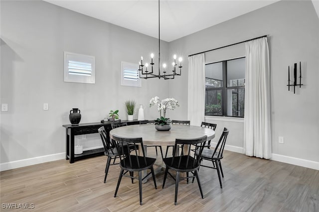 dining area with a notable chandelier and light wood-type flooring