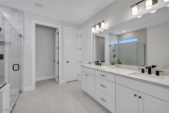 bathroom with vanity and a shower with shower door