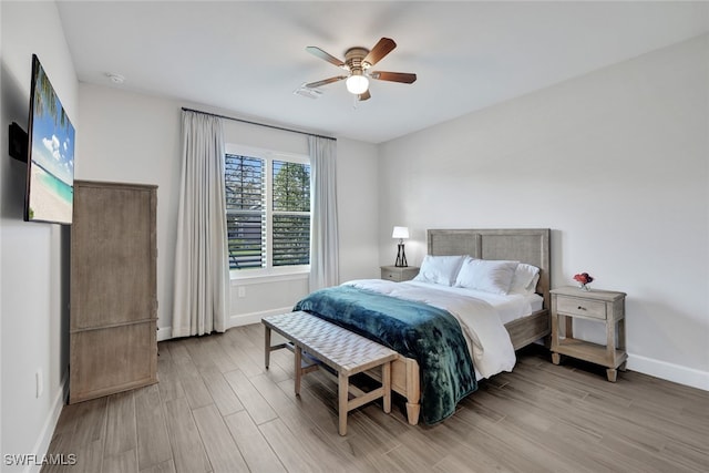 bedroom with ceiling fan and light wood-type flooring