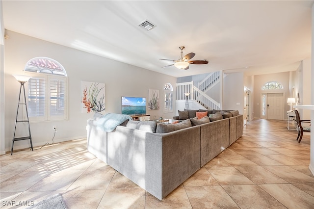 living room with ceiling fan and light tile patterned floors