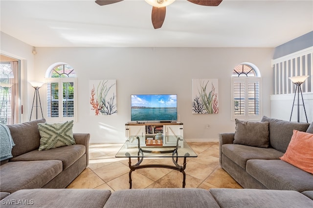 living room with ceiling fan and light tile patterned flooring