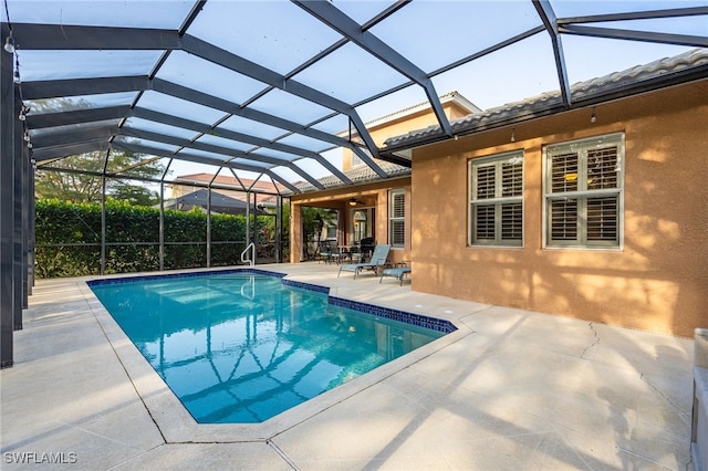 view of pool featuring a patio and glass enclosure