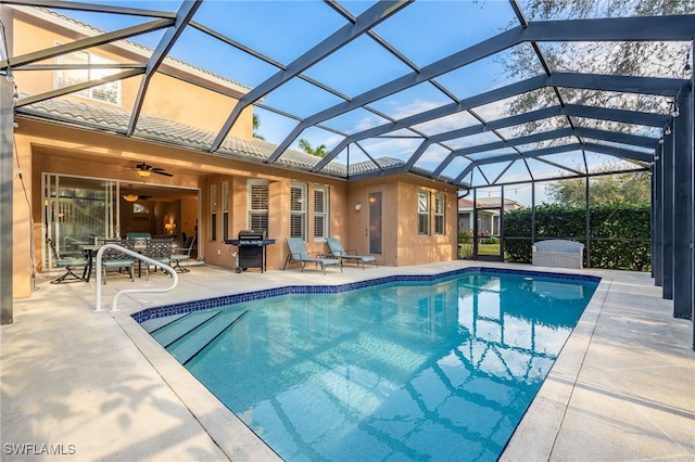 view of pool with a grill, a patio, ceiling fan, and glass enclosure