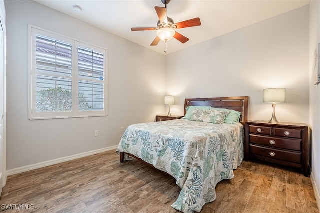 bedroom with ceiling fan and wood-type flooring