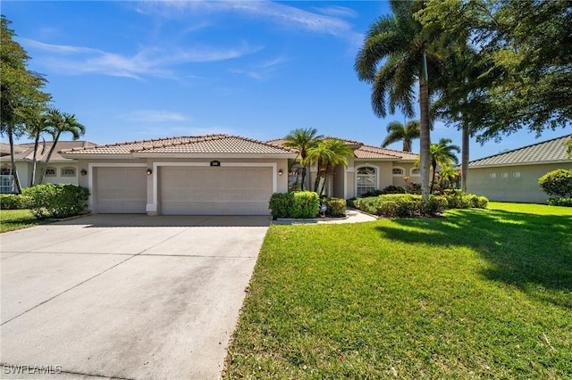 view of front of home with stucco siding, concrete driveway, a garage, a tiled roof, and a front lawn