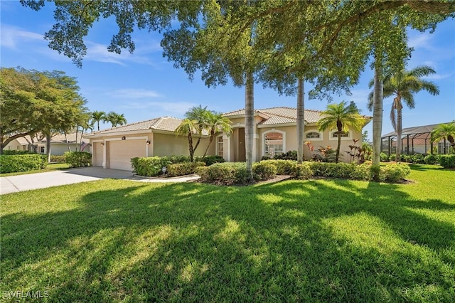 mediterranean / spanish house featuring an attached garage, a tile roof, a front lawn, and concrete driveway