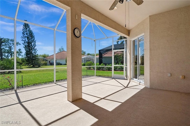 doorway with a sunroom and a ceiling fan