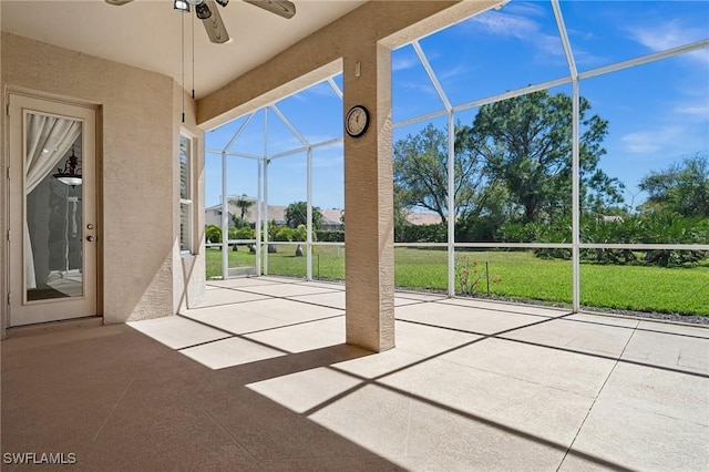 unfurnished sunroom with a ceiling fan