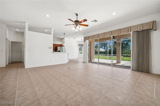 unfurnished living room with light tile patterned floors, recessed lighting, visible vents, baseboards, and a ceiling fan