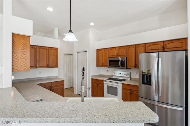 kitchen featuring brown cabinets, stainless steel appliances, and recessed lighting