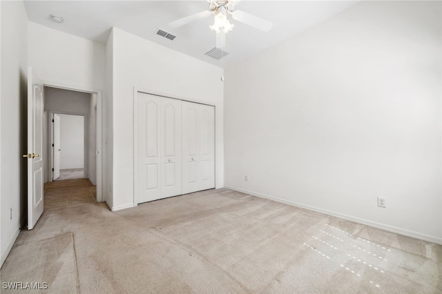 unfurnished bedroom with baseboards, visible vents, ceiling fan, carpet, and a closet