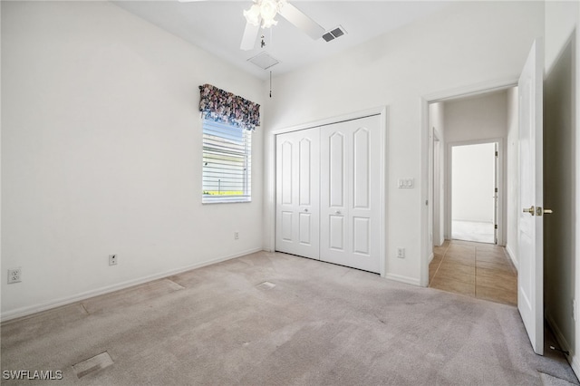 unfurnished bedroom with carpet, a closet, visible vents, attic access, and baseboards