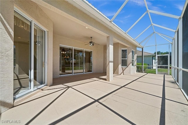 view of patio with glass enclosure and ceiling fan