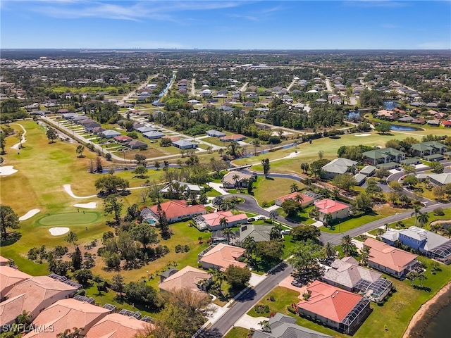 drone / aerial view featuring view of golf course and a residential view