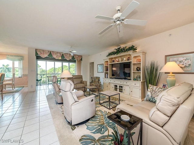 living room featuring ceiling fan and light tile patterned flooring