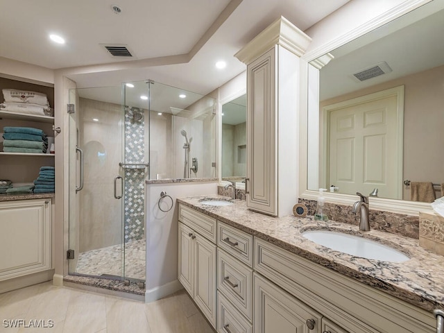 bathroom with vanity and a shower with shower door