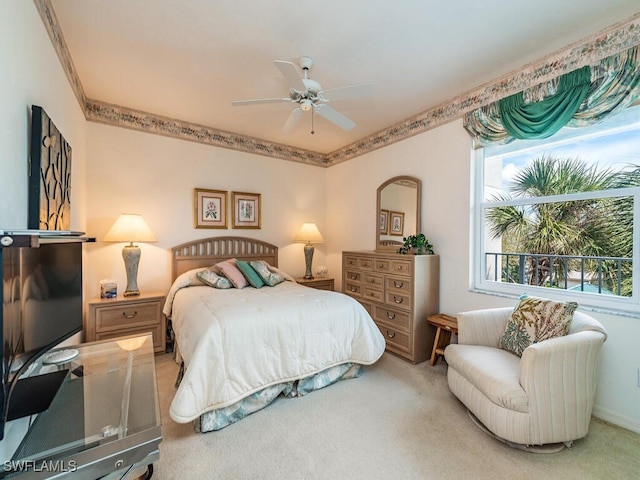 carpeted bedroom featuring ceiling fan and ornamental molding