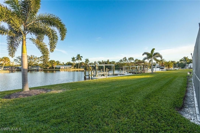 dock area with a yard and a water view