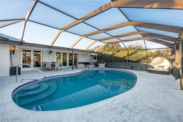 view of pool featuring a lanai, a patio, and french doors