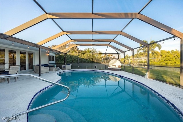 view of swimming pool featuring french doors, glass enclosure, and a patio area