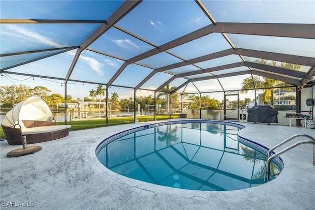 view of swimming pool with a patio area, a water view, and glass enclosure