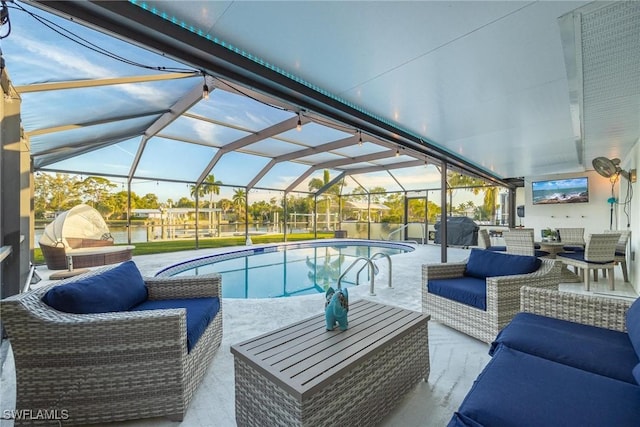 view of swimming pool featuring an outdoor hangout area, glass enclosure, and a patio area