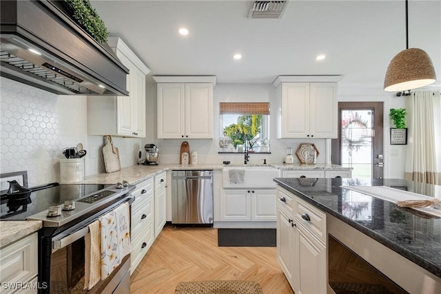 kitchen featuring sink, stainless steel appliances, white cabinets, decorative light fixtures, and custom exhaust hood