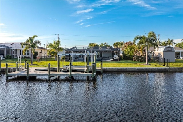 dock area featuring a water view and a lawn