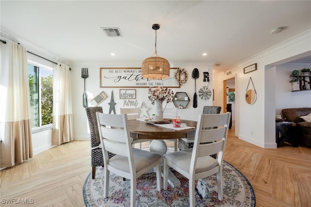 dining area with crown molding and light parquet flooring