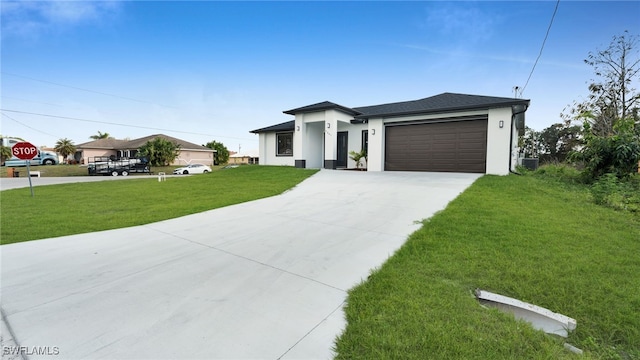 view of front of house featuring a garage and a front lawn