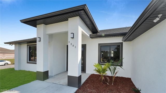 doorway to property with a yard