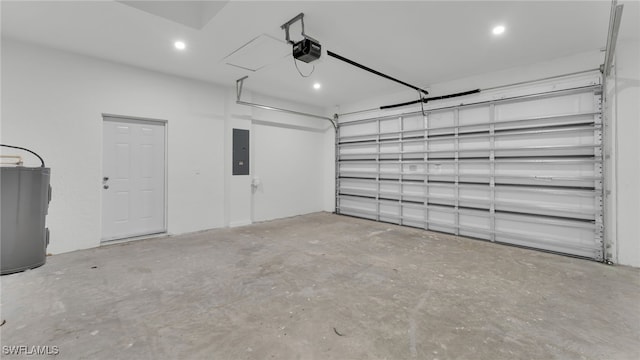 garage featuring a garage door opener, electric panel, and water heater