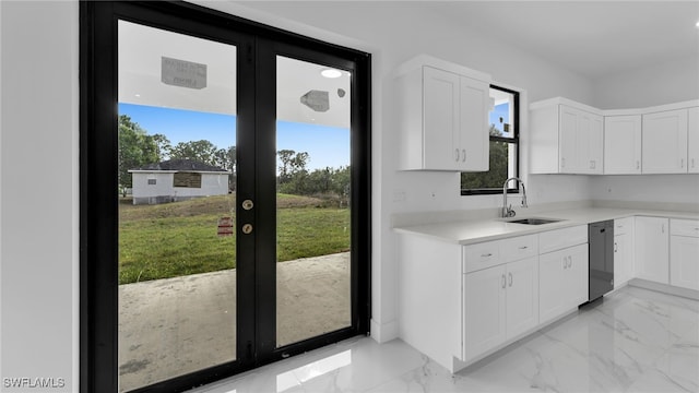 kitchen with white cabinetry, stainless steel dishwasher, and sink