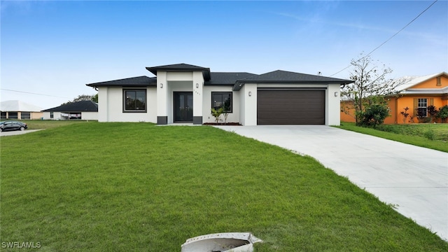 view of front facade with a garage and a front lawn