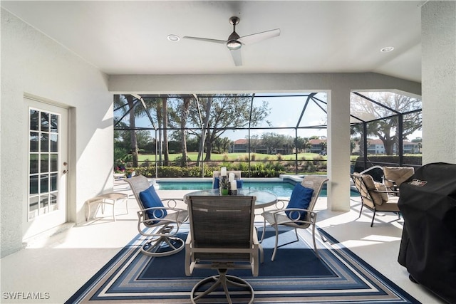 view of patio / terrace with a lanai, grilling area, and ceiling fan