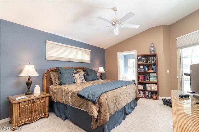 carpeted bedroom featuring lofted ceiling, connected bathroom, and ceiling fan