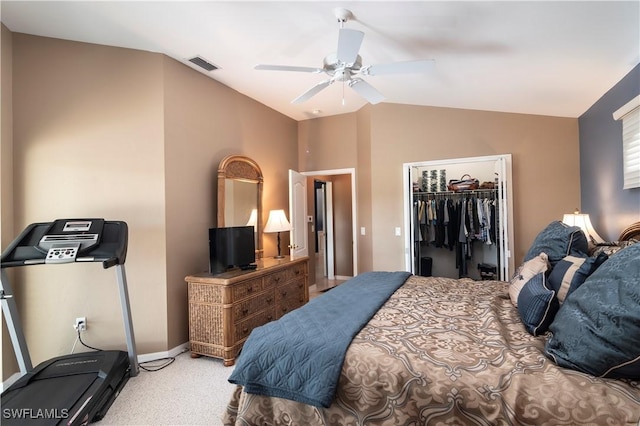 bedroom featuring ceiling fan, light carpet, a spacious closet, vaulted ceiling, and a closet