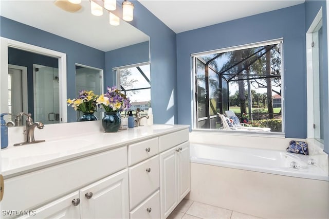 bathroom featuring vanity, a wealth of natural light, tile patterned floors, and separate shower and tub