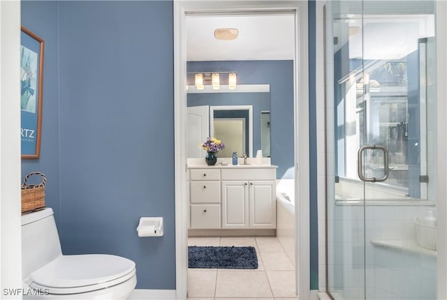 bathroom with tile patterned flooring, vanity, a shower with door, and toilet