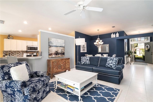 living room featuring ceiling fan with notable chandelier and light tile patterned flooring