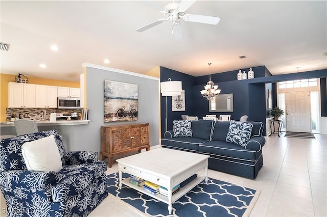 living room with ceiling fan with notable chandelier and light tile patterned floors